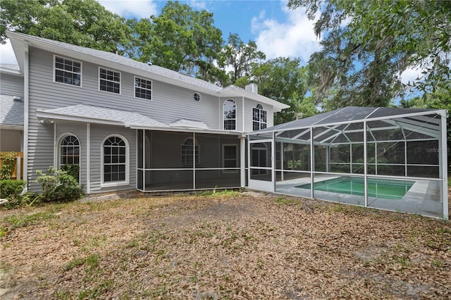 1628 SE 29th Ter, Ocala, FL 34471 - back of property featuring a chimney, an outdoor pool, a patio area, and glass enclosure