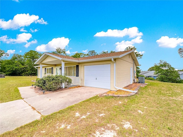 10520 SW 85th Ter, Ocala, FL 34481 - view of front facade featuring cooling unit, a garage, a front yard, and asphalt driveway