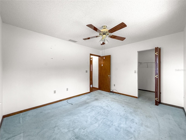 10520 SW 85th Ter, Ocala, FL 34481 - unfurnished bedroom with baseboards, a spacious closet, light colored carpet, a textured ceiling, and a closet