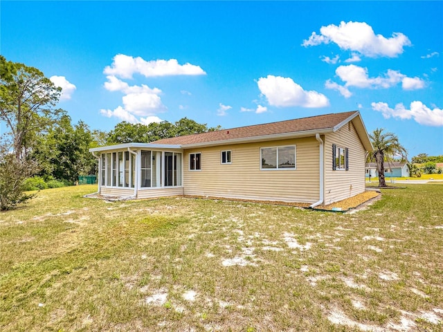 10520 SW 85th Ter, Ocala, FL 34481 - rear view of property featuring a sunroom and a lawn