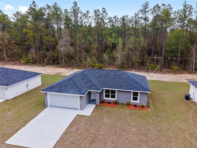 14790 SW 32nd Pl, Ocala, FL 34481 - ranch-style house with a garage, concrete driveway, stucco siding, and a front yard