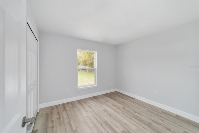 15424 SW 27th Ln, Ocala, FL 34481 - unfurnished bedroom with light wood-style floors, a closet, and baseboards