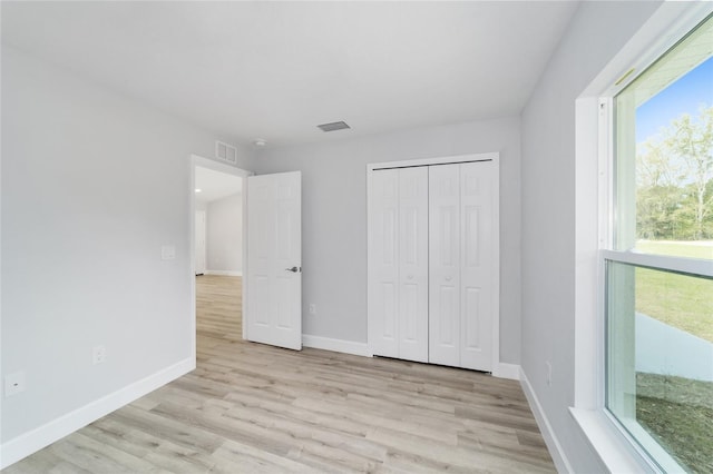 15424 SW 27th Ln, Ocala, FL 34481 - unfurnished bedroom featuring light wood finished floors, baseboards, and a closet