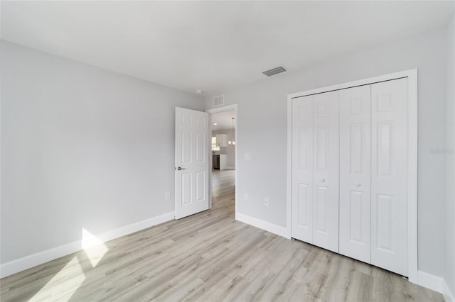 15424 SW 27th Ln, Ocala, FL 34481 - unfurnished bedroom with light wood-style floors, baseboards, and a closet