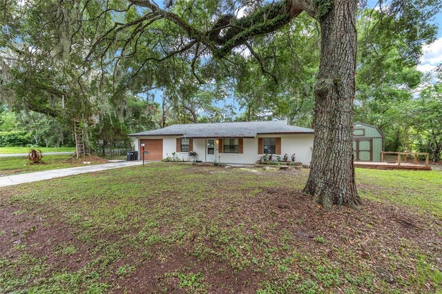 3800 NE 24th Ct, Ocala, FL 34479 - ranch-style house featuring concrete driveway, stucco siding, a front lawn, and an attached garage