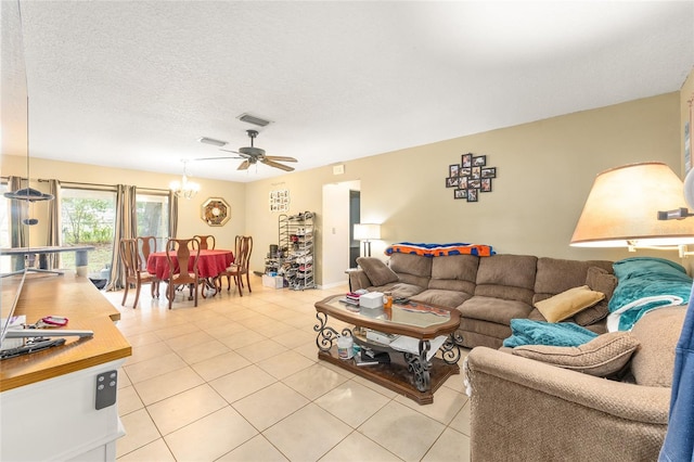 3800 NE 24th Ct, Ocala, FL 34479 - living area featuring light tile patterned floors, ceiling fan, a textured ceiling, and a chandelier