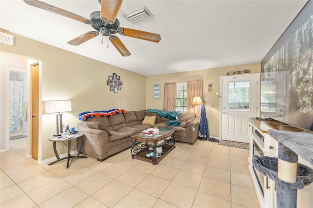 3800 NE 24th Ct, Ocala, FL 34479 - living area featuring light tile patterned floors, ceiling fan, a textured ceiling, and baseboards