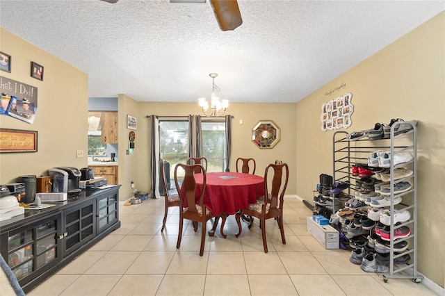 3800 NE 24th Ct, Ocala, FL 34479 - dining space featuring a chandelier, ceiling fan, light tile patterned floors, and a textured ceiling