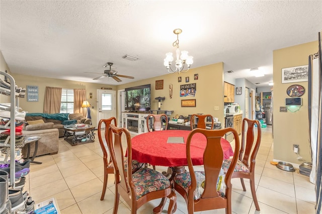 3800 NE 24th Ct, Ocala, FL 34479 - dining room featuring light tile patterned flooring, a textured ceiling, ceiling fan, and a chandelier