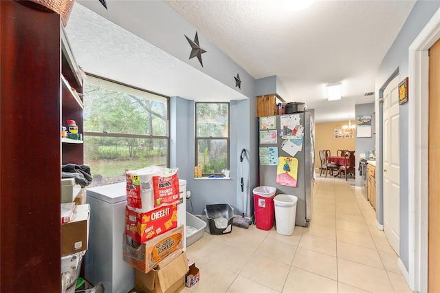 3800 NE 24th Ct, Ocala, FL 34479 - interior space featuring light tile patterned flooring, a textured ceiling, and a chandelier