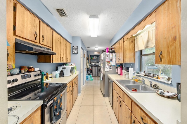 3800 NE 24th Ct, Ocala, FL 34479 - kitchen with appliances with stainless steel finishes, under cabinet range hood, a sink, light countertops, and light tile patterned flooring