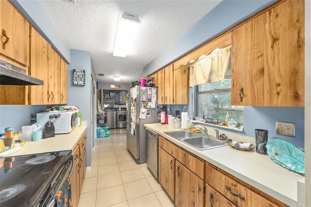 3800 NE 24th Ct, Ocala, FL 34479 - kitchen featuring appliances with stainless steel finishes, a sink, light countertops, light tile patterned floors, and a textured ceiling