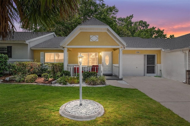 9290 SW 89th Ter Unit D, Ocala, FL 34481 - view of front of house featuring a garage, concrete driveway, stucco siding, and a yard