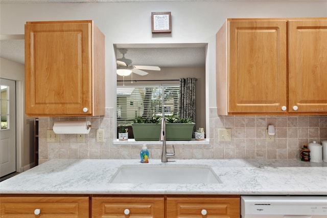 9290 SW 89th Ter Unit D, Ocala, FL 34481 - kitchen featuring white dishwasher, a sink, a ceiling fan, and decorative backsplash