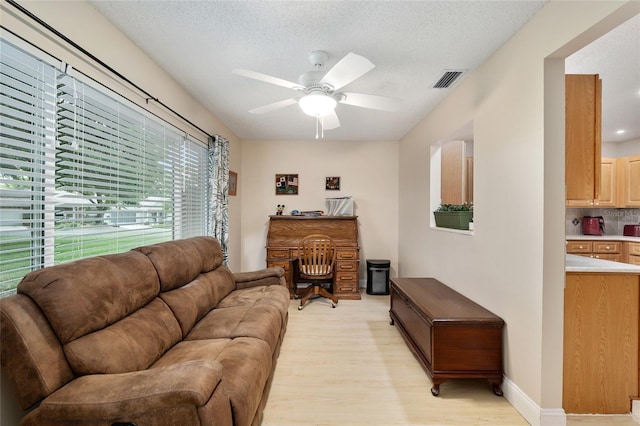 9290 SW 89th Ter Unit D, Ocala, FL 34481 - living area with ceiling fan, light wood-style flooring, and a textured ceiling