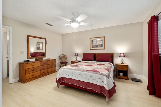 9290 SW 89th Ter Unit D, Ocala, FL 34481 - bedroom featuring light wood-style flooring, baseboards, ceiling fan, and a textured ceiling