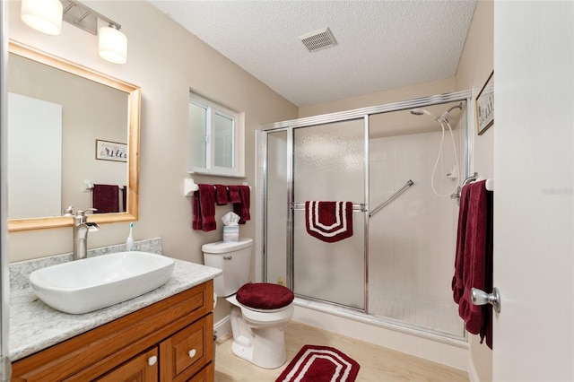 9290 SW 89th Ter Unit D, Ocala, FL 34481 - full bath with vanity, toilet, a shower stall, and a textured ceiling