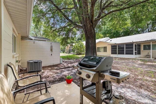 9290 SW 89th Ter Unit D, Ocala, FL 34481 - view of patio featuring a sunroom, central air condition unit, and a grill