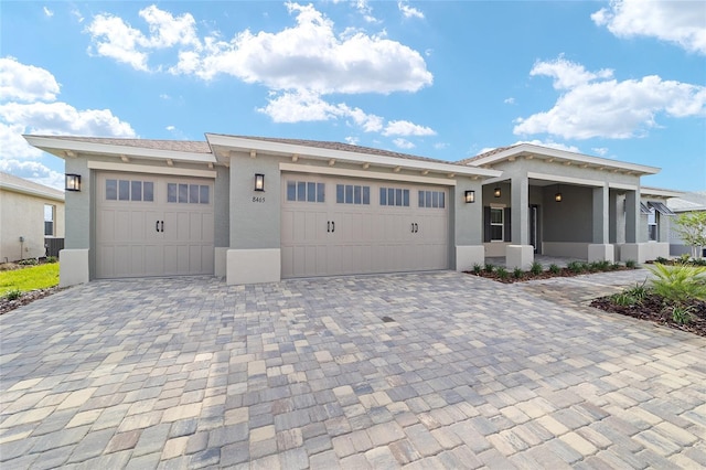 8465 SW 101st Ave, Ocala, FL 34481 - view of front of house with stucco siding, an attached garage, and decorative driveway