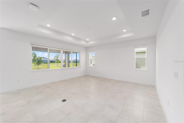 8465 SW 101st Ave, Ocala, FL 34481 - spare room featuring a tray ceiling, recessed lighting, baseboards, and light tile patterned floors