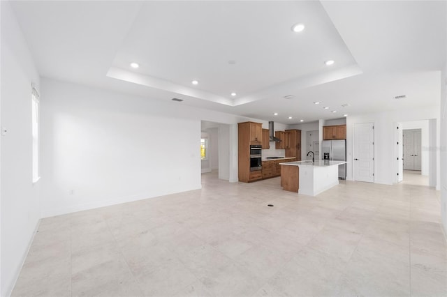 8465 SW 101st Ave, Ocala, FL 34481 - unfurnished living room with a raised ceiling, recessed lighting, baseboards, and a sink
