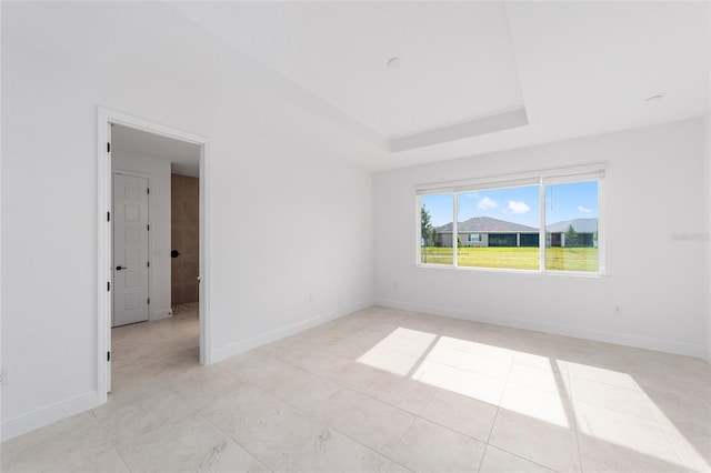 8465 SW 101st Ave, Ocala, FL 34481 - empty room featuring light tile patterned floors, baseboards, and a tray ceiling