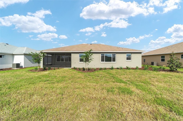 8465 SW 101st Ave, Ocala, FL 34481 - rear view of house featuring central AC unit, a sunroom, and a lawn