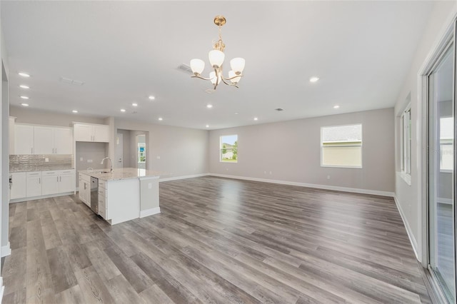 10625 SW 98th Pl, Ocala, FL 34481 - unfurnished living room featuring a sink, light wood-style floors, a chandelier, recessed lighting, and baseboards