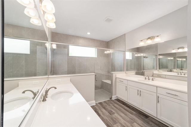 10625 SW 98th Pl, Ocala, FL 34481 - full bath featuring two vanities, a stall shower, wood finished floors, and a chandelier
