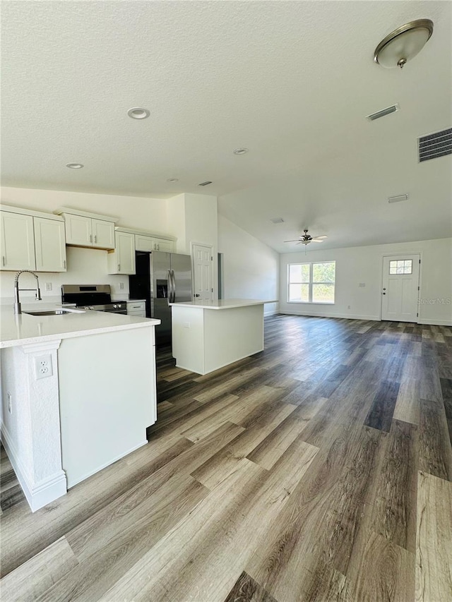 12282 SW 80th St, Dunnellon, FL 34432 - kitchen with a sink, appliances with stainless steel finishes, light countertops, a ceiling fan, and vaulted ceiling