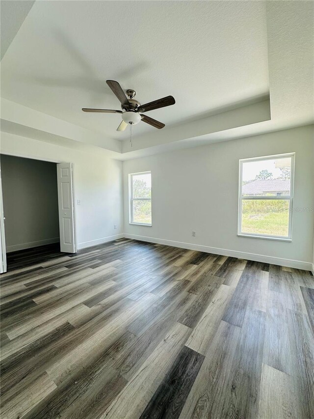 12282 SW 80th St, Dunnellon, FL 34432 - unfurnished bedroom featuring dark wood-style flooring, baseboards, and a ceiling fan