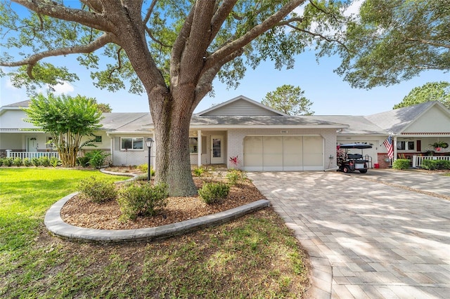 8998 SW 94th St Unit D, Ocala, FL 34481 - single story home featuring an attached garage, brick siding, decorative driveway, and a front lawn