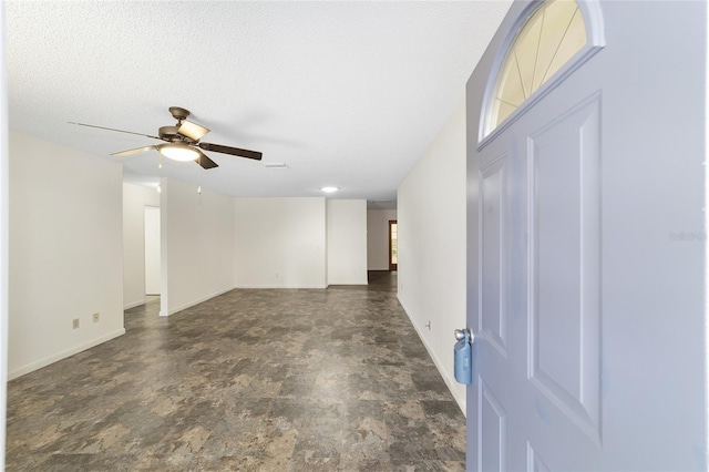 8998 SW 94th St Unit D, Ocala, FL 34481 - entryway featuring a ceiling fan, baseboards, and stone finish flooring
