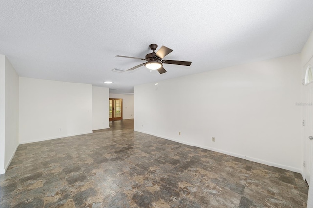 8998 SW 94th St Unit D, Ocala, FL 34481 - empty room with ceiling fan, stone finish floors, baseboards, and a textured ceiling