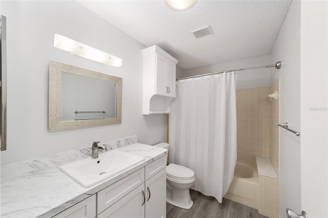 8998 SW 94th St Unit D, Ocala, FL 34481 - bathroom featuring vanity, toilet, wood finished floors, and a textured ceiling