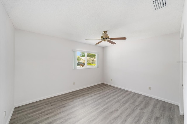 8998 SW 94th St Unit D, Ocala, FL 34481 - empty room featuring light wood-type flooring, ceiling fan, baseboards, and a textured ceiling