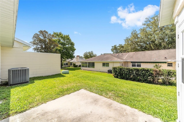 8998 SW 94th St Unit D, Ocala, FL 34481 - view of green lawn with central AC and a patio area