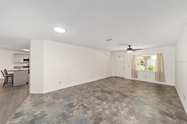 8998 SW 94th St Unit D, Ocala, FL 34481 - spare room with a ceiling fan, a textured ceiling, and baseboards
