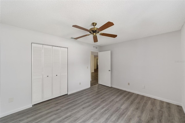 8998 SW 94th St Unit D, Ocala, FL 34481 - unfurnished bedroom with wood finished floors, a closet, and baseboards