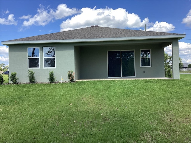 10540 SW 49th Avenue Rd, Ocala, FL 34476 - rear view of house featuring stucco siding, a yard, and a shingled roof