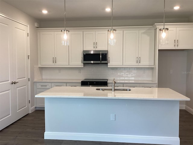 10540 SW 49th Avenue Rd, Ocala, FL 34476 - kitchen featuring stainless steel microwave, stove, a sink, recessed lighting, and white cabinets