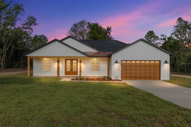 8200 SW 125th Court Rd, Dunnellon, FL 34432 - modern inspired farmhouse featuring french doors, an attached garage, a yard, and driveway