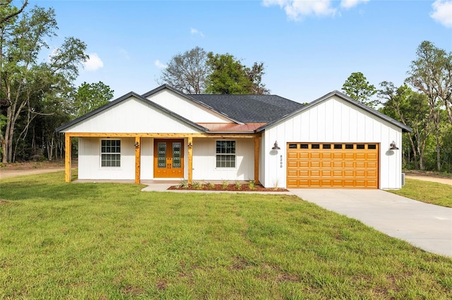 8200 SW 125th Court Rd, Dunnellon, FL 34432 - modern farmhouse style home featuring a garage, a front lawn, french doors, and driveway