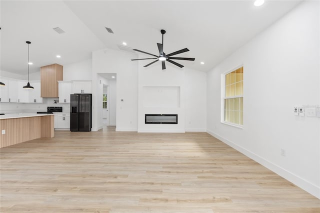8200 SW 125th Court Rd, Dunnellon, FL 34432 - unfurnished living room featuring ceiling fan, a glass covered fireplace, light wood-style floors, recessed lighting, and high vaulted ceiling