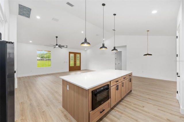 8200 SW 125th Court Rd, Dunnellon, FL 34432 - kitchen with freestanding refrigerator, lofted ceiling, light wood-style floors, ceiling fan, and hanging light fixtures
