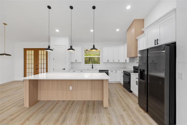 8200 SW 125th Court Rd, Dunnellon, FL 34432 - kitchen with black electric range oven, a sink, light wood-style floors, stainless steel fridge with ice dispenser, and recessed lighting