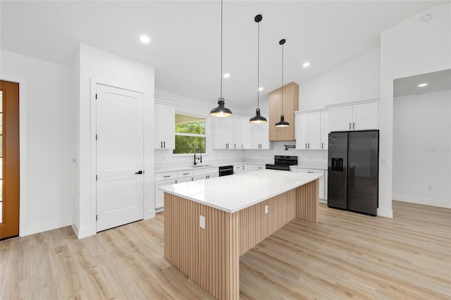 8200 SW 125th Court Rd, Dunnellon, FL 34432 - kitchen featuring stainless steel fridge with ice dispenser, black electric range, light wood finished floors, a kitchen island, and light countertops