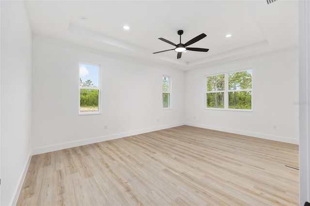 8200 SW 125th Court Rd, Dunnellon, FL 34432 - unfurnished room with a raised ceiling, light wood-style flooring, ceiling fan, baseboards, and recessed lighting