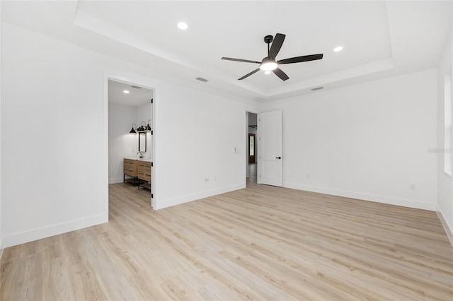 8200 SW 125th Court Rd, Dunnellon, FL 34432 - spare room featuring a raised ceiling, recessed lighting, light wood-style flooring, ceiling fan, and baseboards