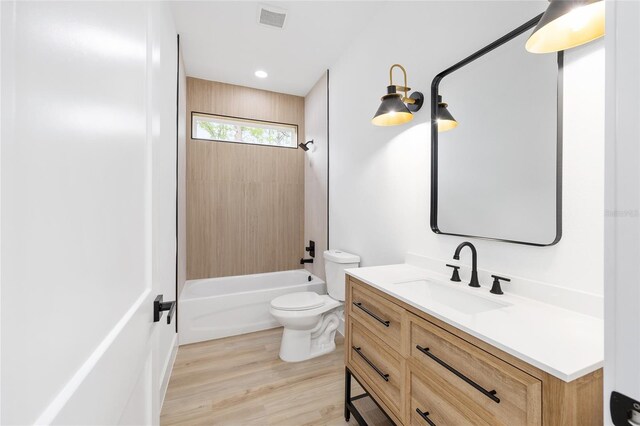 8200 SW 125th Court Rd, Dunnellon, FL 34432 - bathroom with vanity, toilet, wood finished floors, shower / bathtub combination, and recessed lighting